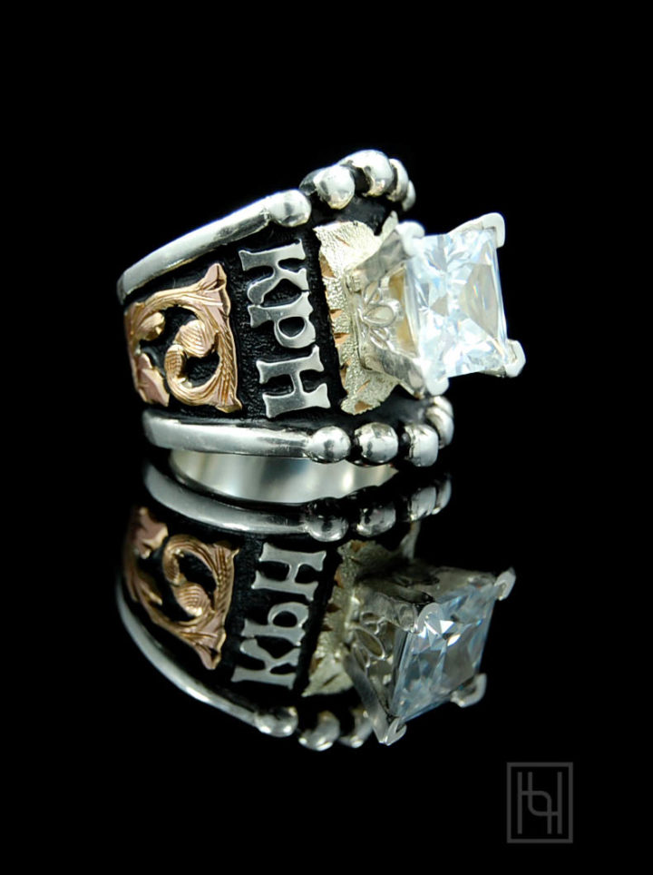 Black background w/ rose gold scrolls, yellow gold leaf, silver lettering and 8mm crystal clear cz stone on prong setting
