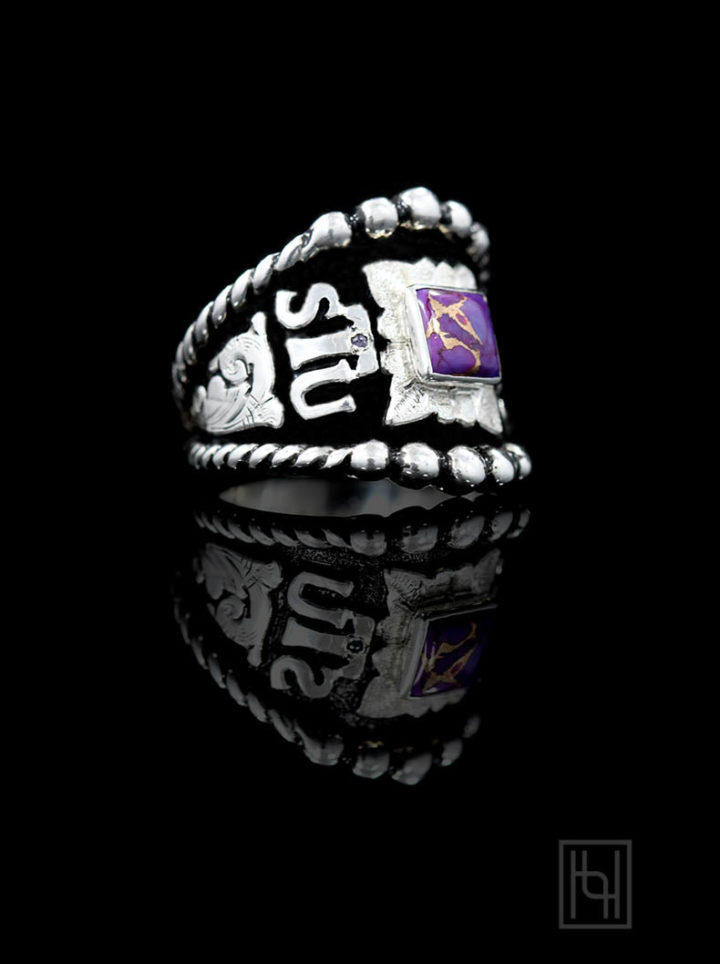 Black background w/ silver scrolls, lettering and leaf, 6mm purple turquoise square stone