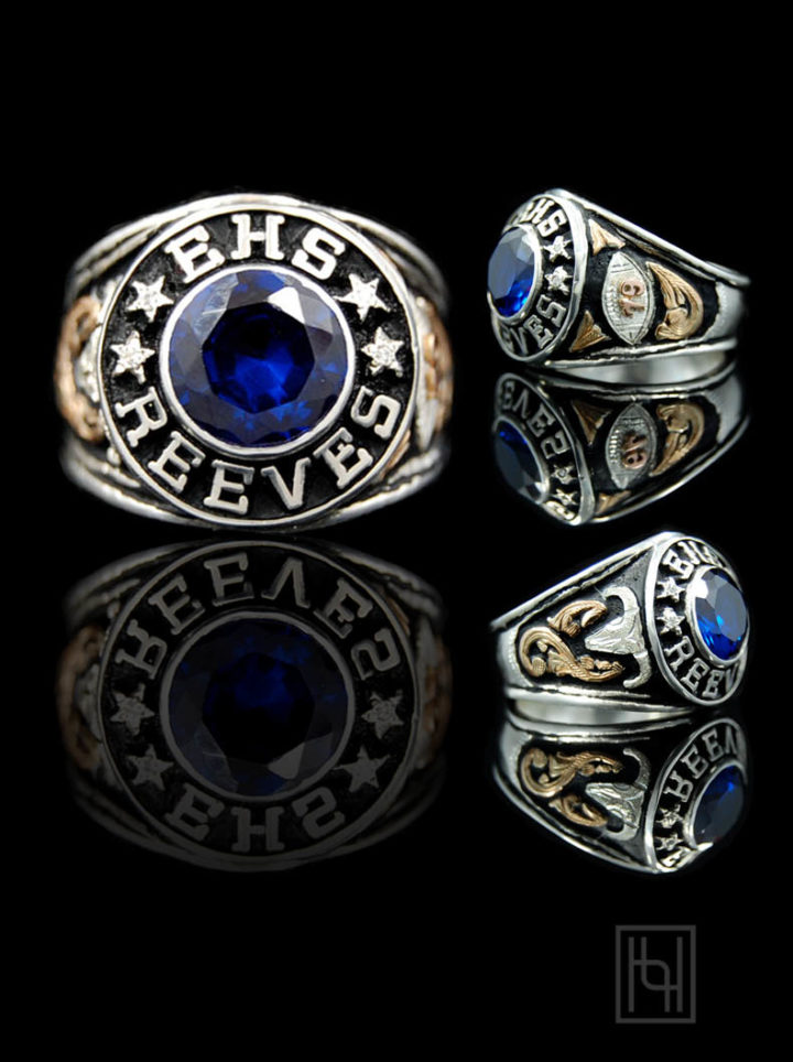 Silver men's class ring with black background and yellow gold scrolls, 10amm faceted sapphire blue cz round stone, silver lettering and figures