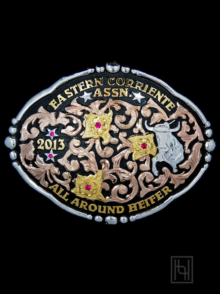 Black background w/ rose gold scrolls, yellow gold lettering and flowers, silver bull figure, ruby red cz stones