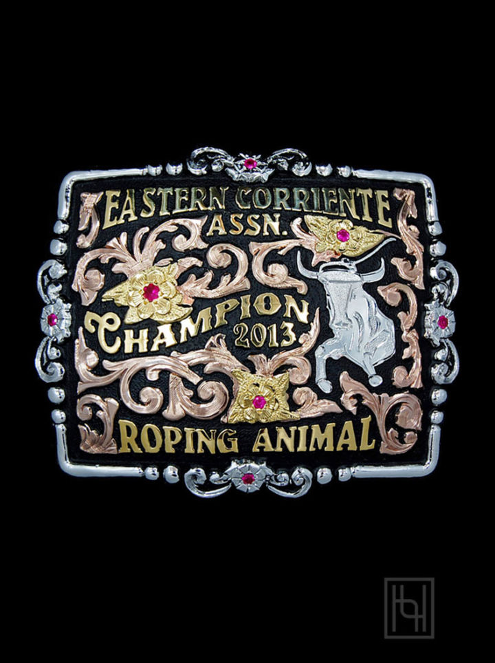 Black background with rose gold scrolls, yellow gold lettering and flowers, ruby red cz stones, silver etched bull figure