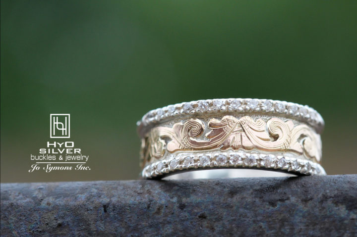 Lifestyle photo of R055, silver ring with yellow gold scrolls and crystal clear accent stones in edge