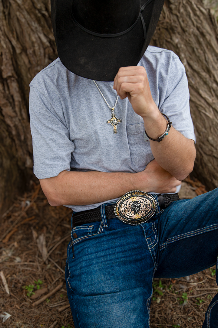 Team Roping Champion buckle on a cowboy model