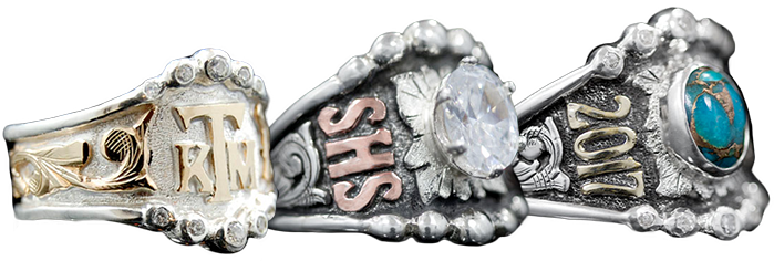 Banner - white background and three sterling silver custom class rings