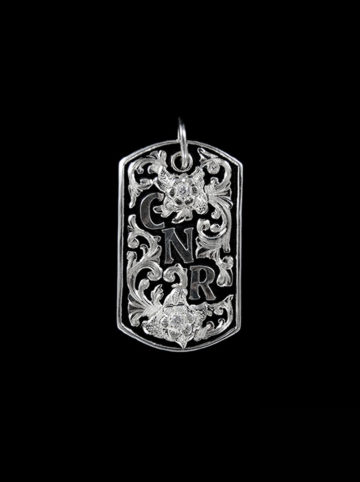 Sterling silver dogtag w/ black background and silver scrolls, silver lettering and flowers w/ crystal clear cz stones