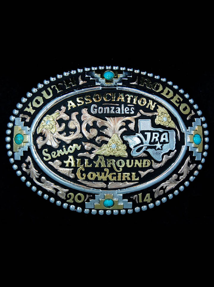 Rose Gold Scrolls on Black Background, Yellow Gold & Silver Lettering, Silver Texas Figure/Logo, Yellow Gold Flowers & Leaves w/ Crystal Cleat Accents, Blue Turquoise Accents in Beaded Edge