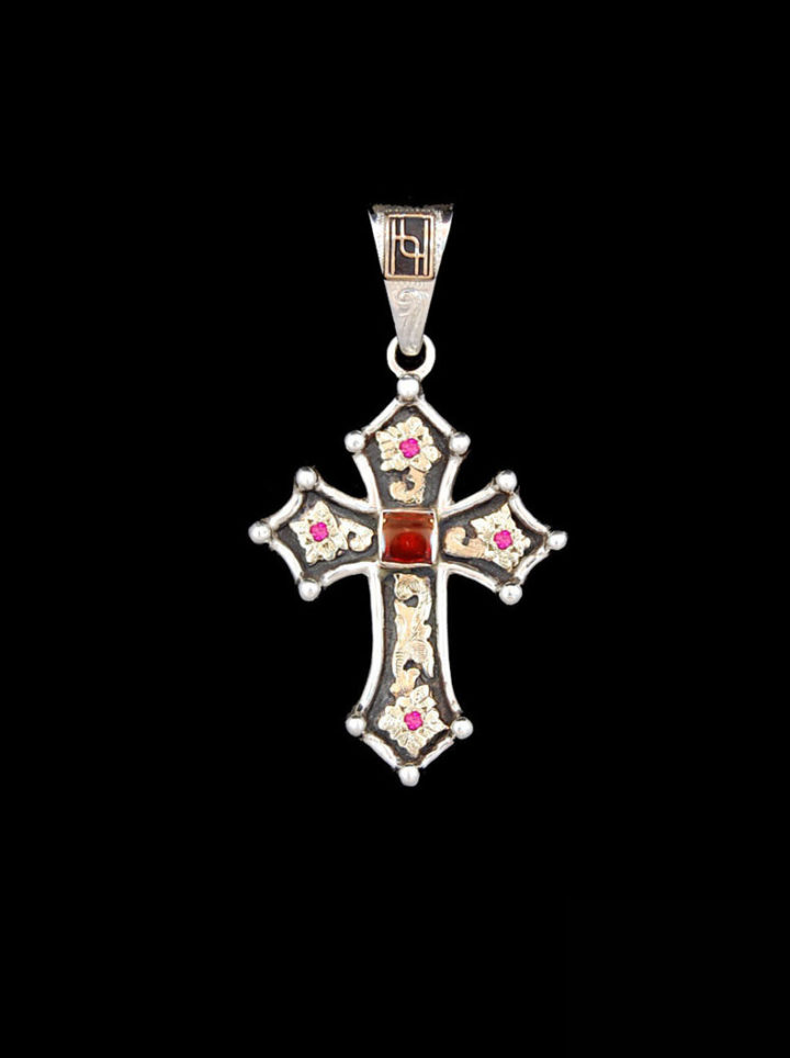 Sterling silver cross with oxidized background, yellow gold scrolls, and genuine garnet 6mm stone and ruby red cz