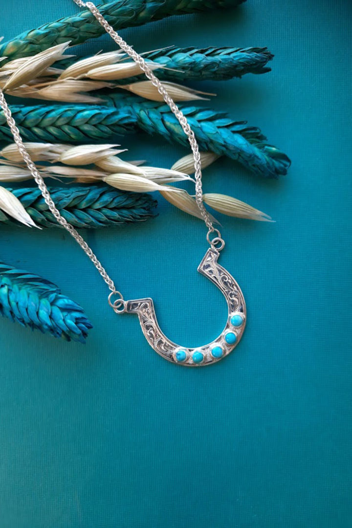 Silver Horseshoe shaped pendant set with Turquoise Stones